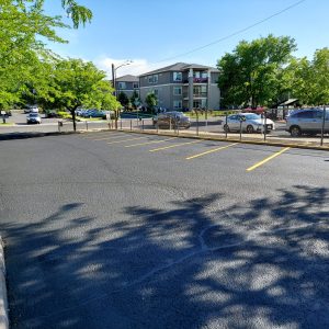 Smooth & sleek parking lot in Spokane. Firstly, we did Crack Fil. Secondly, we Seal coated. Lastly, we striped. In conclusion, call us today for quality work.