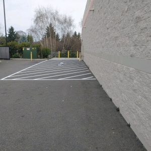 A safe lot with new striping and Bollards, which are types of Wheel Stops. They, especially, keep lots safe.